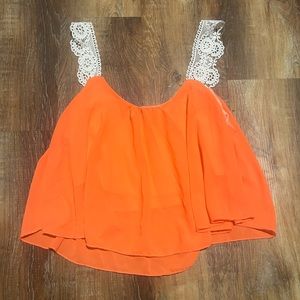 loose orange cropped tank top. lace straps. worn once.